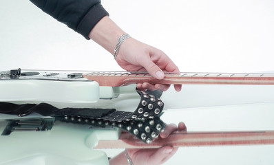 closeup.the hand of the musician stroking the strings of a guit