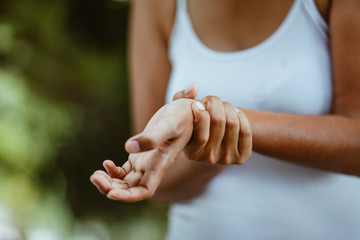 Woman holding her wrist symptomatic