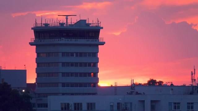 Air traffic radar control tower in airport after thunderstorm at sunset