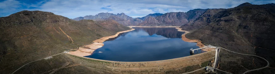 Gordijnen Aerial view over the Bergriver dam in the Bergriver outside Franschhoek in the western cape during the worst drought in decades in South Africa © Dewald