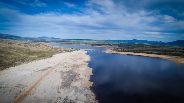Aerial image over a very dry Theewaterskloof dam during the worst drought in decades in the Western Cape of South Africa with massive patches of barren earth exposed