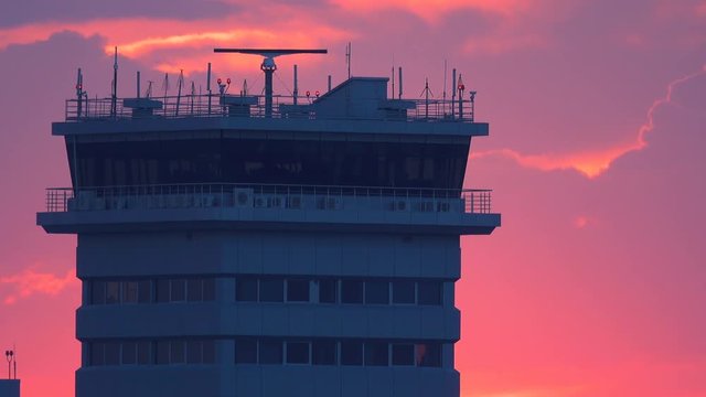 Air traffic radar control tower in airport after thunderstorm at sunset