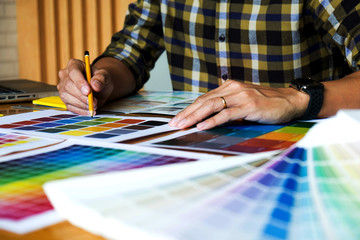 Obraz premium Graphic designers choose colors from the color bands samples for design .Designer graphic creativity work concept .