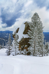 Big stone blocks and fir tree on  top of Mountain Utuya. Winter landscape in ski resort Sheregesh.  Russia, Kemerovo Oblast, Tashtagolsky District, March 2018.