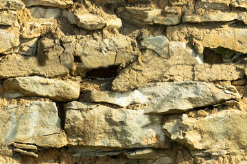 Background texture, stone buds, limestone, basalt, cobblestone, granite, pebbles, slate, sandstone laid the wall or in the fence close up for inscriptions or advertisements. Seamless texture