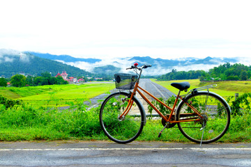 Fototapeta na wymiar bicycle near Airport runway with mountain in countryside