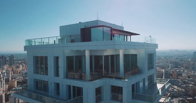 A drone shot moving upwards that reveals city after a building, Israel