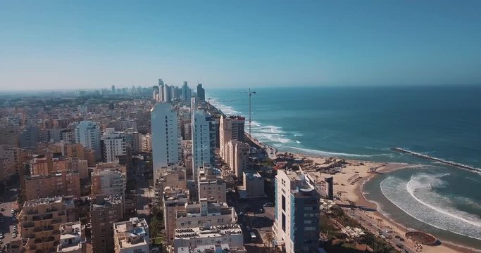 A drone aerial shot upon the city with sea and beach