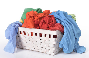 Colorful dirty clothes in laundry basket