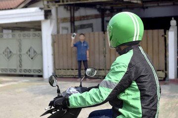 Motorcycle taxi man approached the passenger