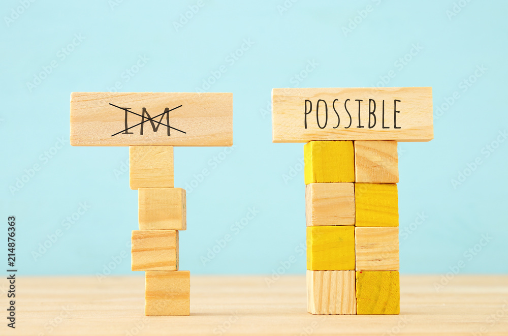 Poster concept image of wooden cubes that create an unstable structure and the word im next to steady one w