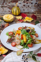 Salad of fresh vegetables with arugula, basil, shrimp and pear