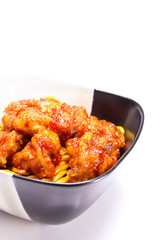 Orange Chicken with chow mein Chinese food in a black and white ceramic bowl