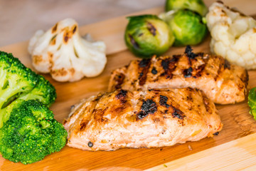 Fried salmon on a blackboard with broccoli, colored and Brussels