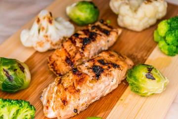 Fried salmon on a blackboard with broccoli, colored and Brussels