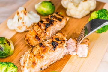 Fried salmon on a blackboard with broccoli, colored and Brussels