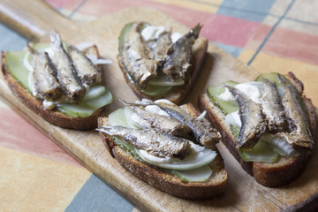 Snack sandwiches with sprats and pickles