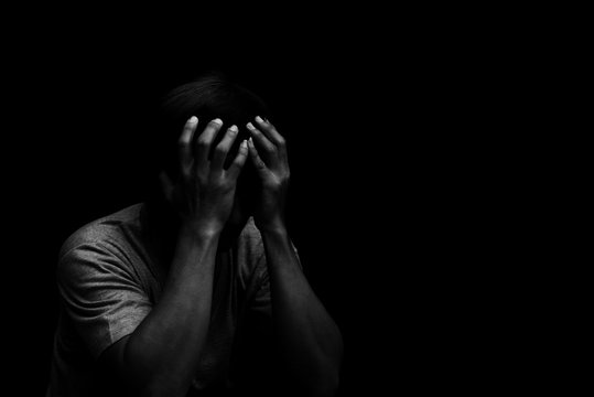 Man Sitting Alone Felling Sad Worry Or Fear And Hands Up On Head On Black Background