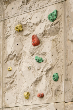 Hand on an artificial climbing wall.