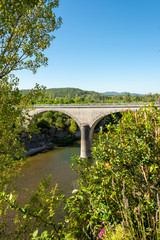 Fototapeta na wymiar Stone bridge over the river Ardeche near Pradons in the department Ardeche
