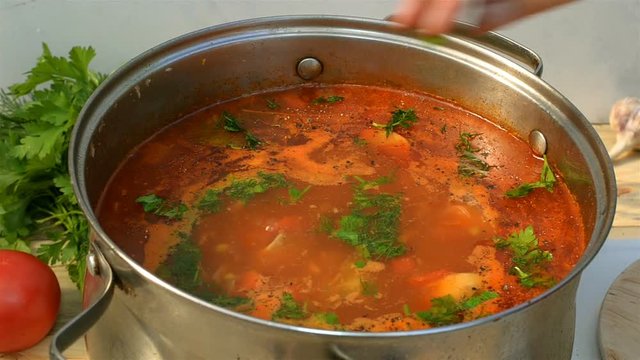 Pot with a homemade appetizing and tasty borsch. Red beetroot vegetable soup, boiling in a saucepan. Ukrainian and russian traditional red soup - borscht or borsch.