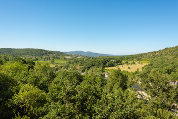 Fototapeta na wymiar Beautiful panoramic view of the landscape in front of a bright blue sky by the river Ardeche in the south of France