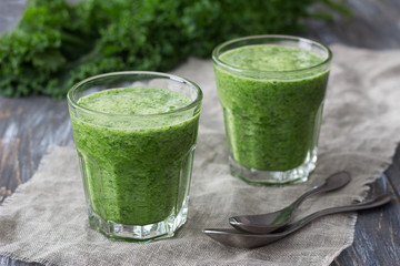 Green smoothies with kale, banana and lemon. on a wooden table. selective focus. healthy diet food