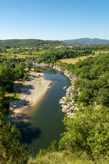 Fototapeta na wymiar Beautiful view of the river Ardeche, framed by forests and gorges at 