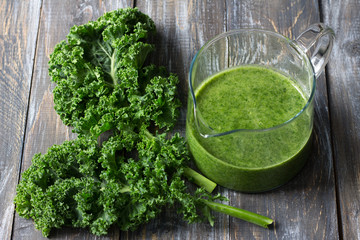 Green smoothies with kale, banana and lemon. on a wooden table. selective focus. healthy diet food