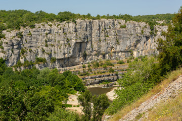 Panorama landscape with the river Ardeche, framed by rock faces and a lot of vegetation at "Cirque des Gens" near the small village Chauzon in the south of France