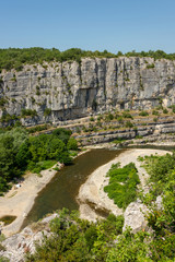 Fototapeta premium Landscape with the river Ardeche, framed by rock faces and much vegetation at 
