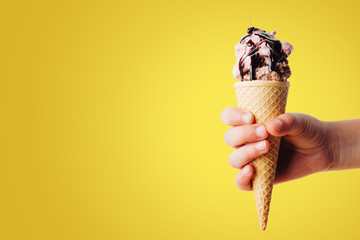 Hand holding ice cream in cones