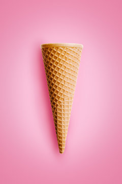 Sweet wafer cone on pink background.