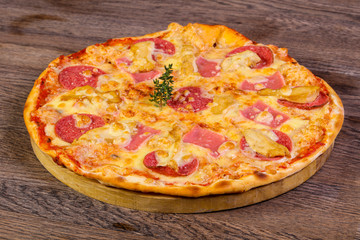Pizza with ham and sausages
