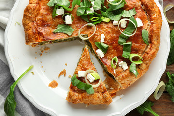 Tasty pie with spinach on plate