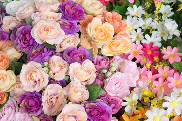 Background of different colorful artificial flowers
