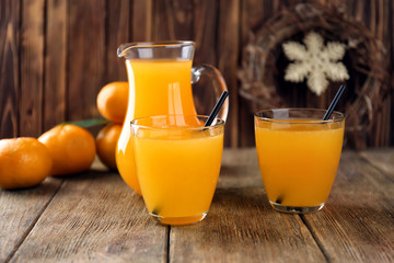 Fresh citrus juice in glasses on table