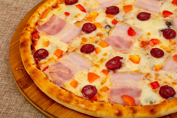 Pizza with ham and sausages