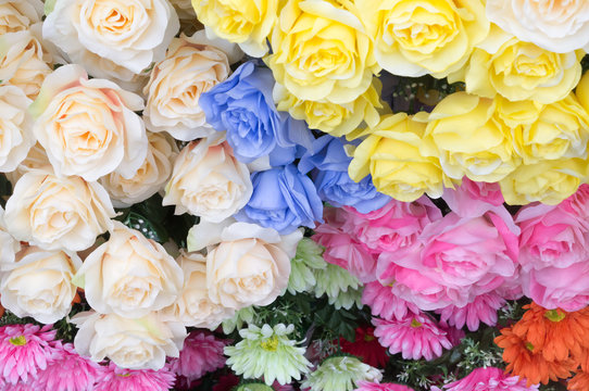 Background of different colorful artificial flowers