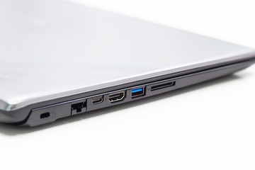 Modern laptop with USB port, HDMI port, Sd Card, and Lan port on its side on white background
