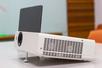 projector connected to Laptop on for  presentation in a meeting room, business concept.