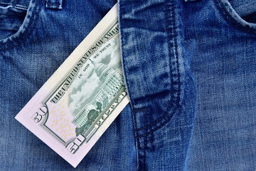 Detail of denim jeans with money. The concept of prostitution and corrupt love. sexual celebrity scandals