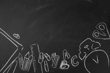 Back to school Accessories for school on a dark background Pencils Plasticine letters Letters Alarm clock Briefcase Chalk Copy space Top view