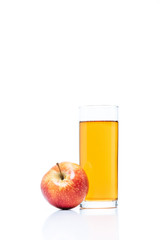 close up view of glass of apple juice and fresh apple isolated on white