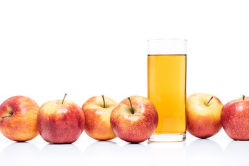 close up view of glass of apple juice and fresh apples isolated on white