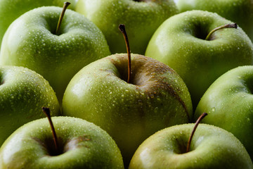 close up view of water drops on fresh apples backdrop