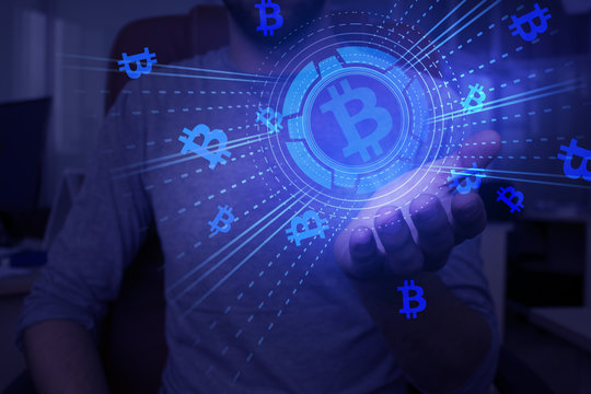 Crypto currency in hand, additional reality, holographic display, neon light, abstract background