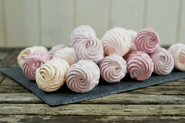A lot of marshmallow in pastel shades of pink, purple. Confectionery art. Banquet or birthday