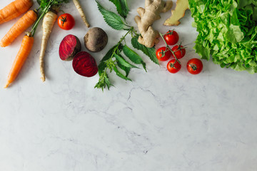 Creative food layout with fruits, vegetables and leaves on bright marble table background. Minimal healthy food concept. Flat lay.