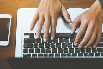 Fototapeta na wymiar Human hands typing on laptop keyboard